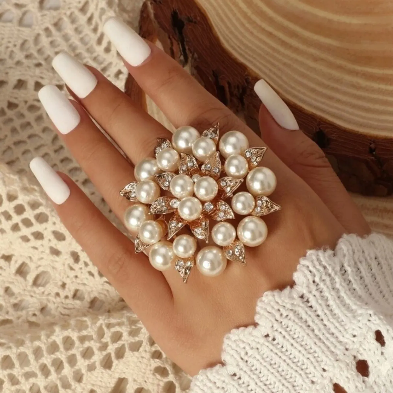 Faux pearl and rhinestone flower ring.